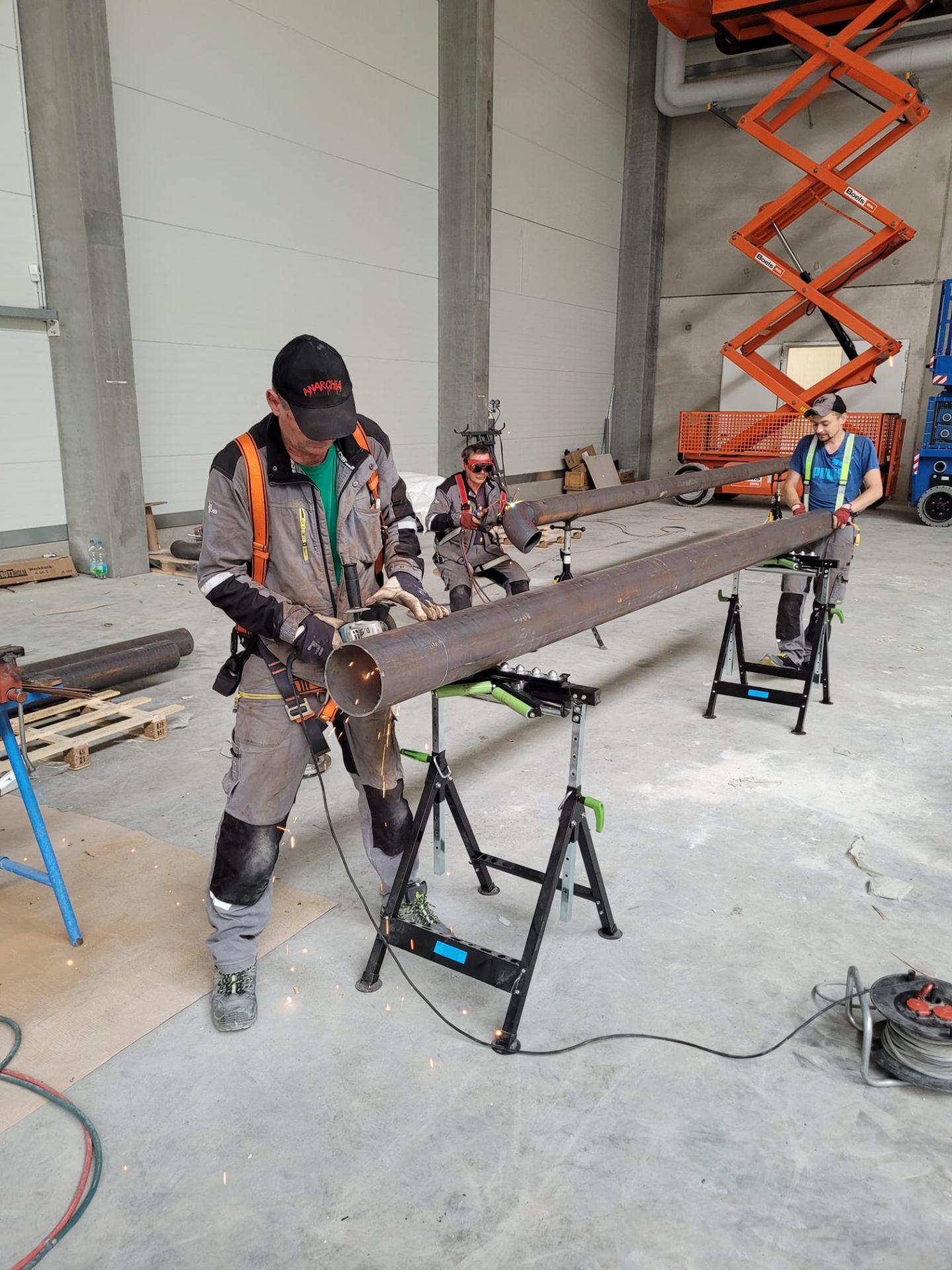 In-shop steel pipe cutting and welding for structural assemblies.