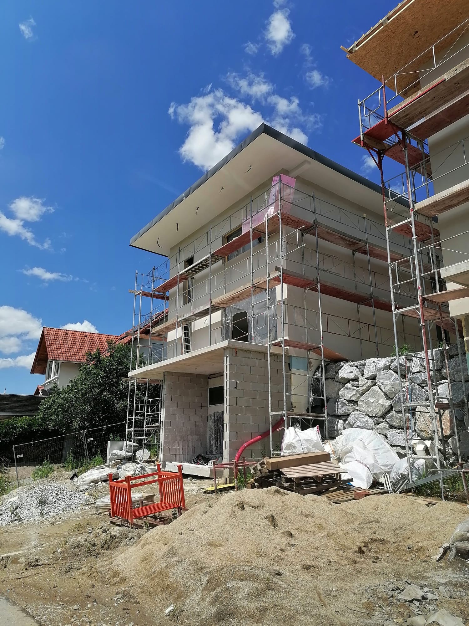Facade insulation and roof detailing on a modern residential project.